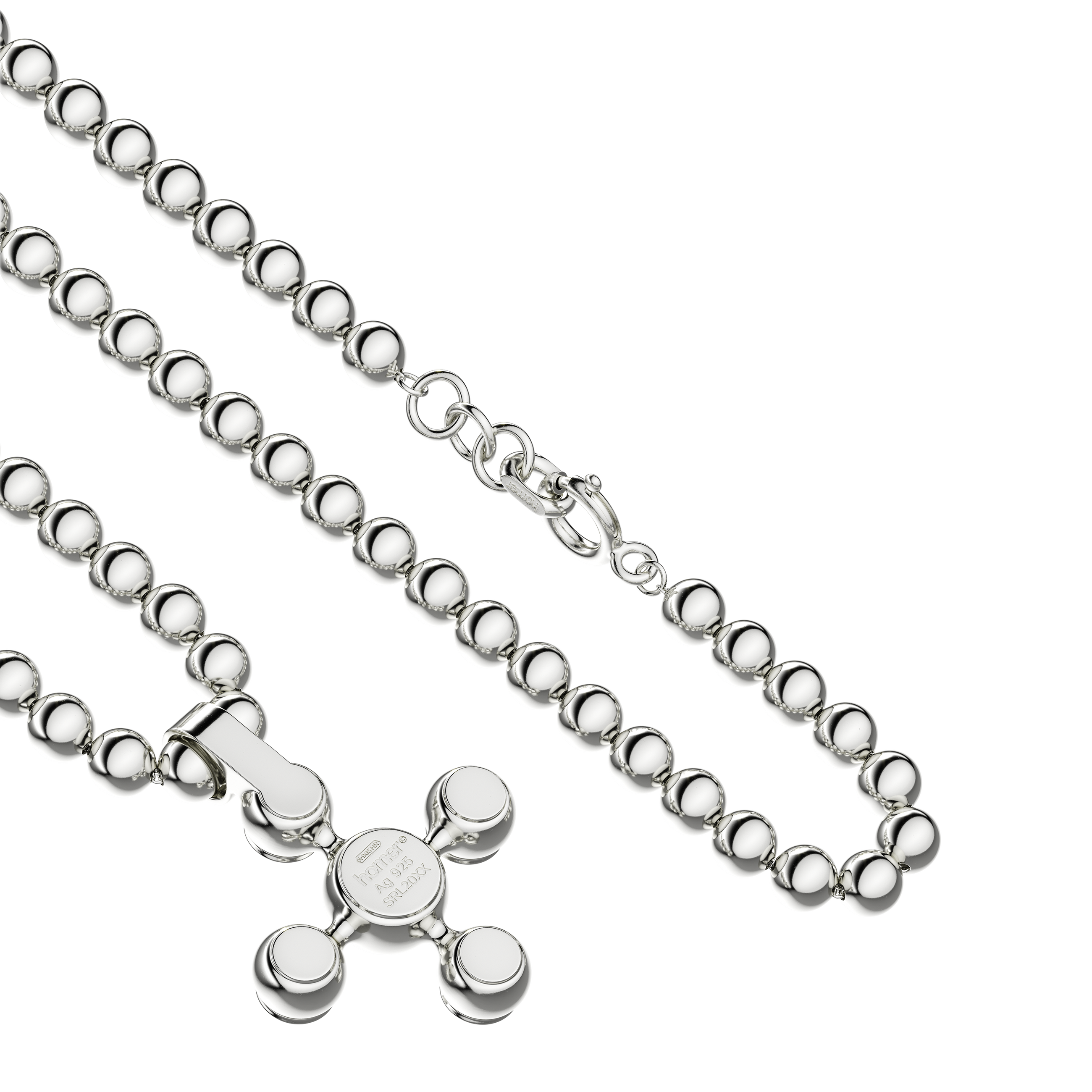 A detail view of Sphere Cross Pendant